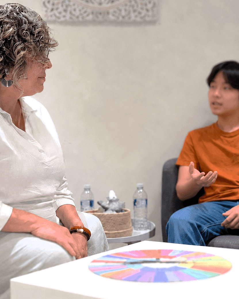 Teen counselling session asian teenage boy sitting with counsellor